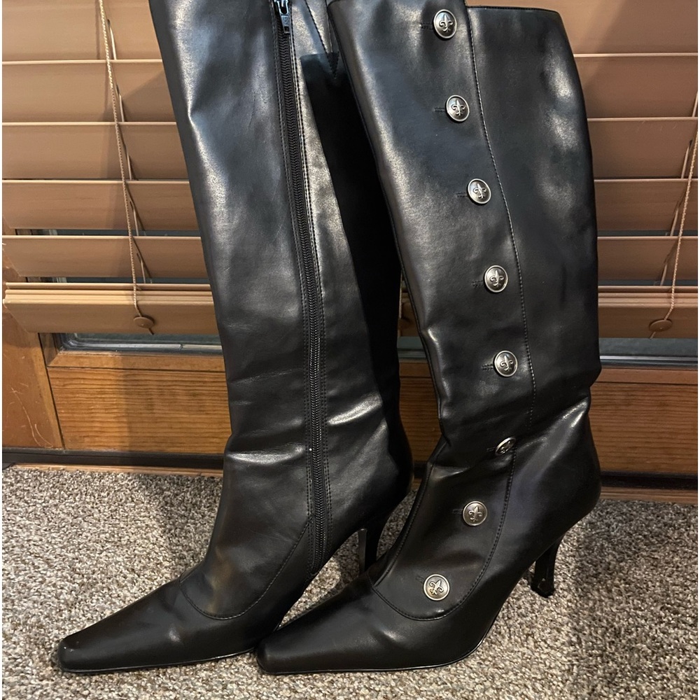 Black, tall, healed boots with decorative buttons. Newer, excellent condition.